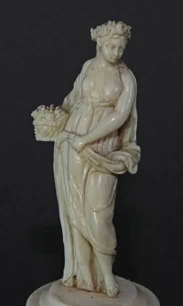 null A series of four carved ivory statuettes symbolizing the four seasons, the one...