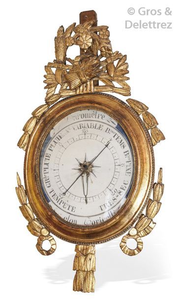 Oval barometer with an openwork pediment,...