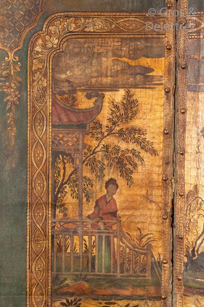 null Four-leaf leather folding screen with polychrome Chinese scenes on a gold background....