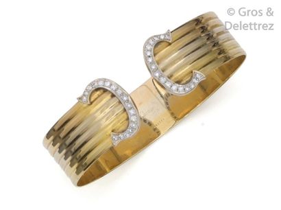 CARTIER Rigid open bracelet in three colours of gold decorated with two " C " set...