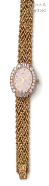 PIAGET Lady's yellow gold watch strap, oval case, gold dial, indexes and bezel set...