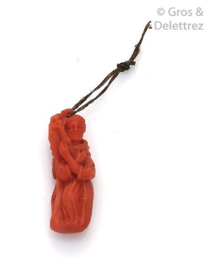 null Double-sided coral pendant representing a character holding a enfant ; on the...
