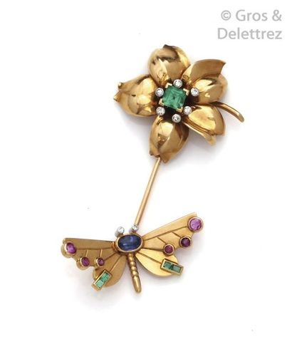 null A yellow gold tie pin, adorned with a flower set with a square emerald in a...