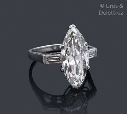 null Platinum ring, adorned with a shuttle-shaped diamond set with two baguette diamonds....