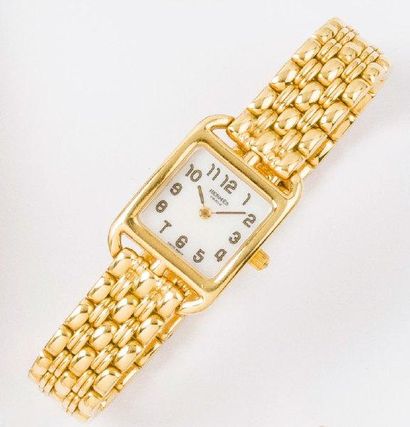 HERMES « Capcod » - Bracelet montre de dame en or jaune, cadran nacre blanche à chiffres...