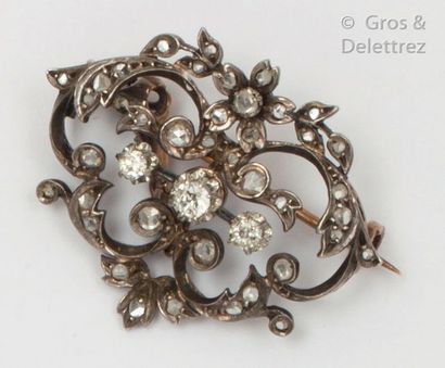 null Brooch " Volutes " in yellow gold and silver decorated with branches and flowers...