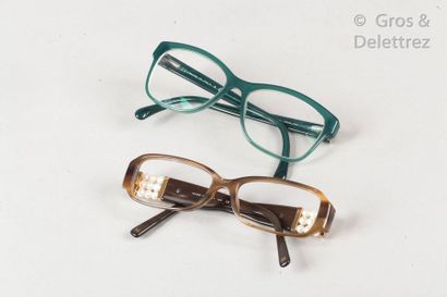CHANEL Set of two pairs of corrective glasses, one in green resin, the other in amber...