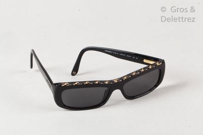 CHANEL *Pair of black resin sunglasses, decorated with a golden metal chain motif...