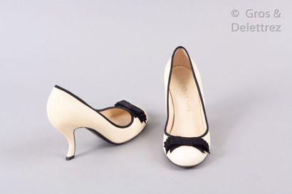 CHANEL Pair of egg-shell lamb leather pumps with black grosgrain trim, uppers decorated...