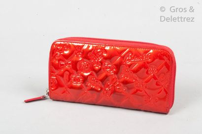 CHANEL Circa 2011 *Zipped red patent leather wallet embossed with the icons of the...