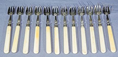 null Twelve oyster forks, moulded ivory handles, silver forks (a few small slits).

Weight...