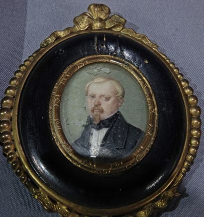 null Two oval miniatures depicting a young boy in a black jacket with buttons and...