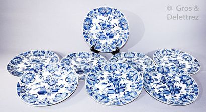 DELFT Suite of eight earthenware plates with floral decoration in blue monochrome....