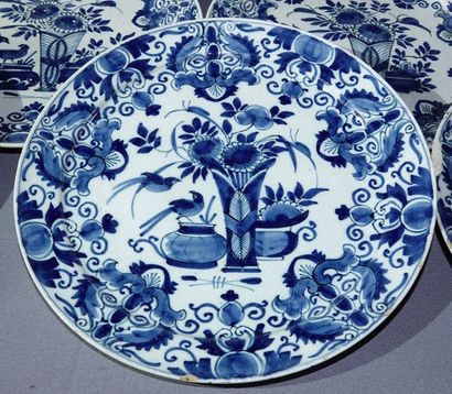 DELFT Suite of eight earthenware plates with floral decoration in blue monochrome....