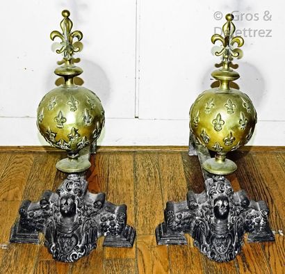 null Pair of cast iron andirons adorned with a brass sphere decorated with fleur-de-lys...