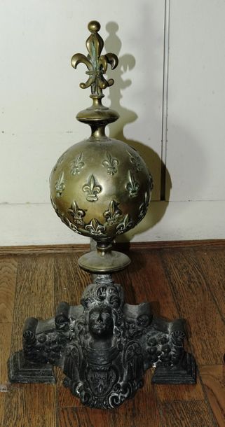 null Pair of cast iron andirons adorned with a brass sphere decorated with fleur-de-lys...