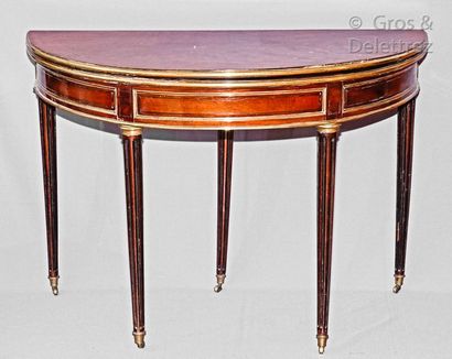 null Mahogany and mahogany veneer half-moon table decorated with brass rods, the...