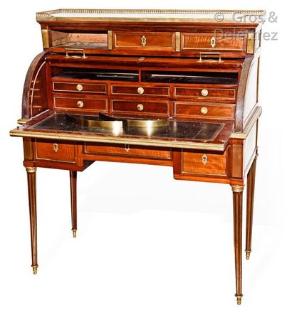 null Mahogany cylinder and mahogany veneer desk inlaid with brass frame rods, opening...