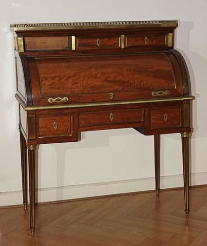 null Mahogany cylinder and mahogany veneer desk inlaid with brass frame rods, opening...