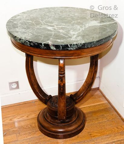 null Pedestal table in mahogany stained wood, moulded and carved, the three uprights...