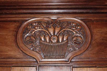 null Moulded and carved natural wood cabinet with a fruit basket in a cartouche shaped...