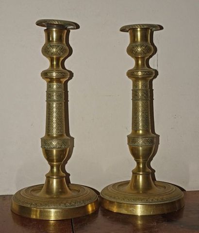 null Pair of brass candleholders chiselled with quartefeuille decoration in rhombuses....