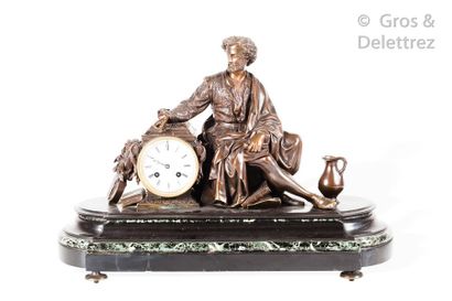 null Clock in black marble and patinated bronze, figure sitting with his hand on...