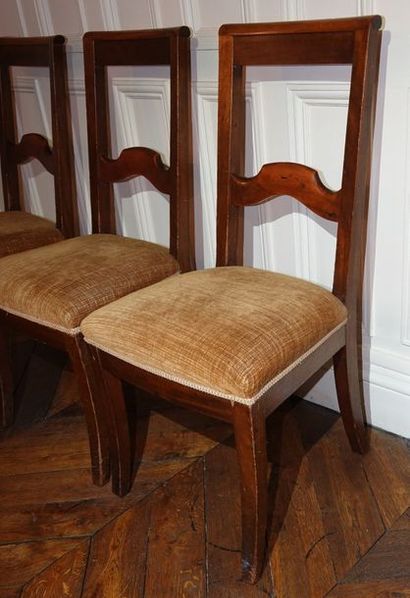 null A suite of three straight chairs in stained wood, the openwork backrest decorated...