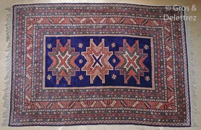 null Carpet decorated with three geometric patterns on a midnight blue and brick...