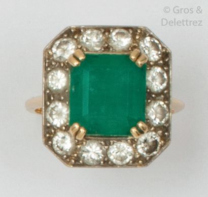null Yellow gold ring, set with a rectangular emerald with stepped-cut sides set...