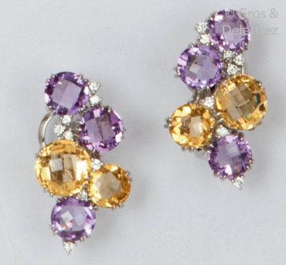 null Pair of white gold ear clips, each adorned with faceted citrines and amethysts...