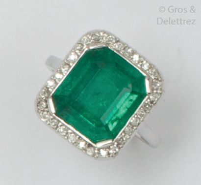 null Platinum ring set with a rectangular emerald with stepped cut sides set with...