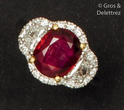 null White gold ring set with an oval ruby set with two half-moon diamonds in a brilliant...