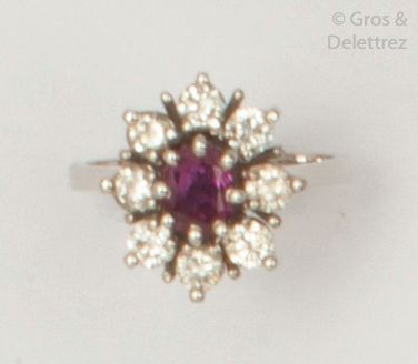 null Ring " Fleur " in white gold, decorated with a ruby in a surround of white stones....