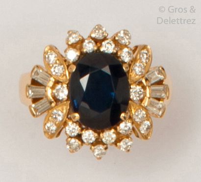 null Ring " Fleur " in yellow gold, adorned with an oval faceted sapphire in a radiant...