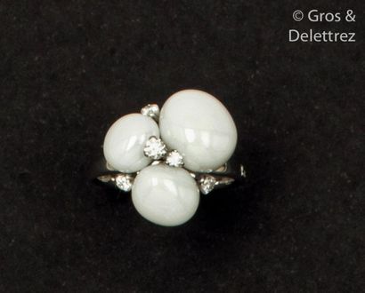 null White gold ring, adorned with three white agate cabochons edged with brilliant-cut...