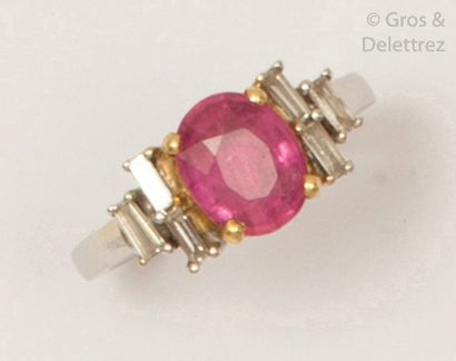 null White and yellow gold ring set with an oval pink tourmaline set with baguette...