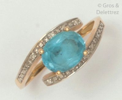 Yellow gold ring set with a blue topaz with...