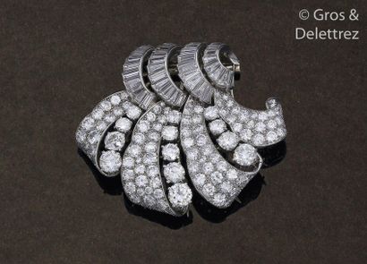 null Brooch consisting of a double lapel clip in white gold and platinum, adorned...