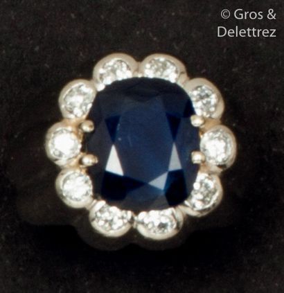 null Platinum gadrooned ring set with an oval sapphire calibrating approximately...