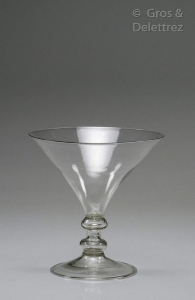 Conical cut glass resting on a hollow leg...