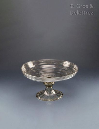null Tazza with undulating hemispherical cut resting on a golden ribbed bow and ribbed...