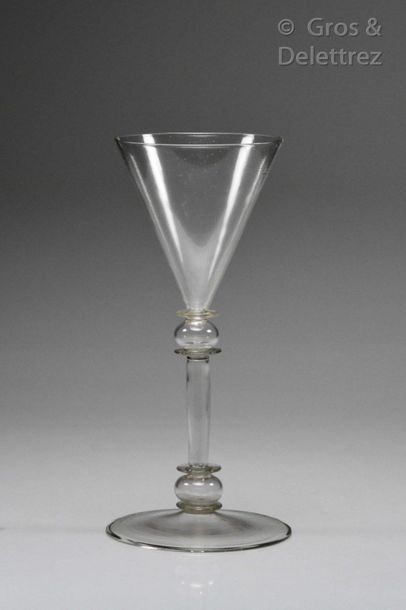 Glass with a conical cut resting on a tubular...
