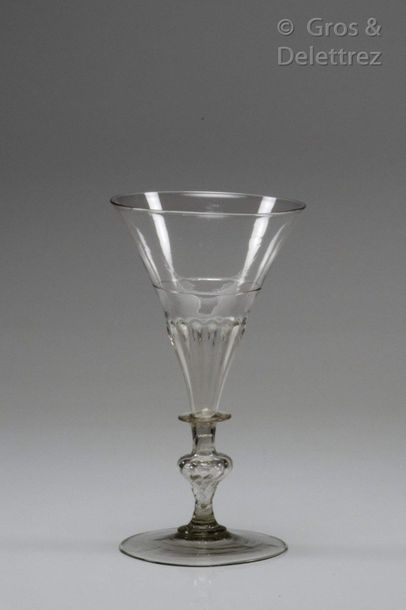 null Glass with a conical cut gadrooned on the base under a glass net and resting...