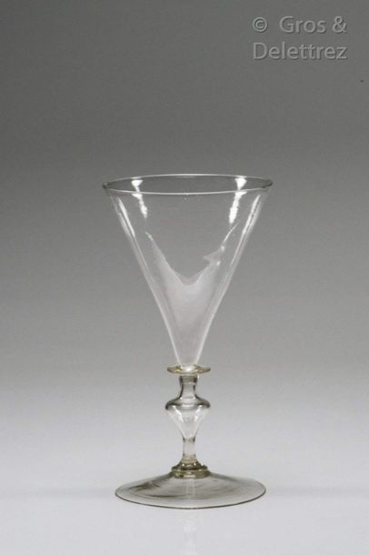 Glass with conical cut resting on a disc...