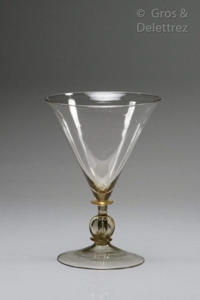 Glass with a wide conical cup resting on...