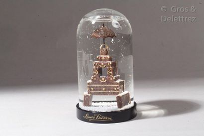 LOUIS VUITTON Eiffel Tower Trunks" snow globe, made up of a stack of the House's...
