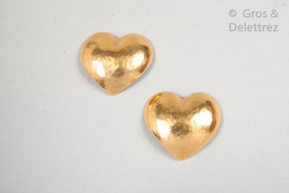 Yves Saint LAURENT Pair of "Heart" ear clips in hammered and beaded gold metal. ...