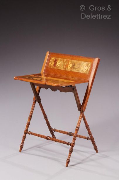 Émile GALLÉ (1846-1904) Folding writing table in carved moulded wood, inlaid top...