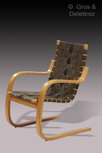 Alvar Aalto (1898-1976) Armchair model 406 in flat curved strips in blond walnut...
